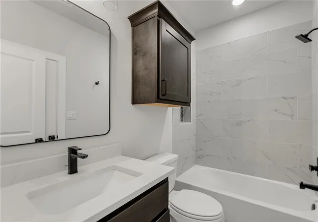 a bathroom with a sink a toilet and bathtub