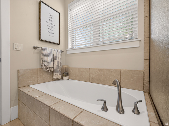 557 Craftsman Way Midway, UT 84049 - Photo 27 of 59 Built-in soaking tub featuring a tiled surround, brushed nickel fixtures, and a privacy window with blinds