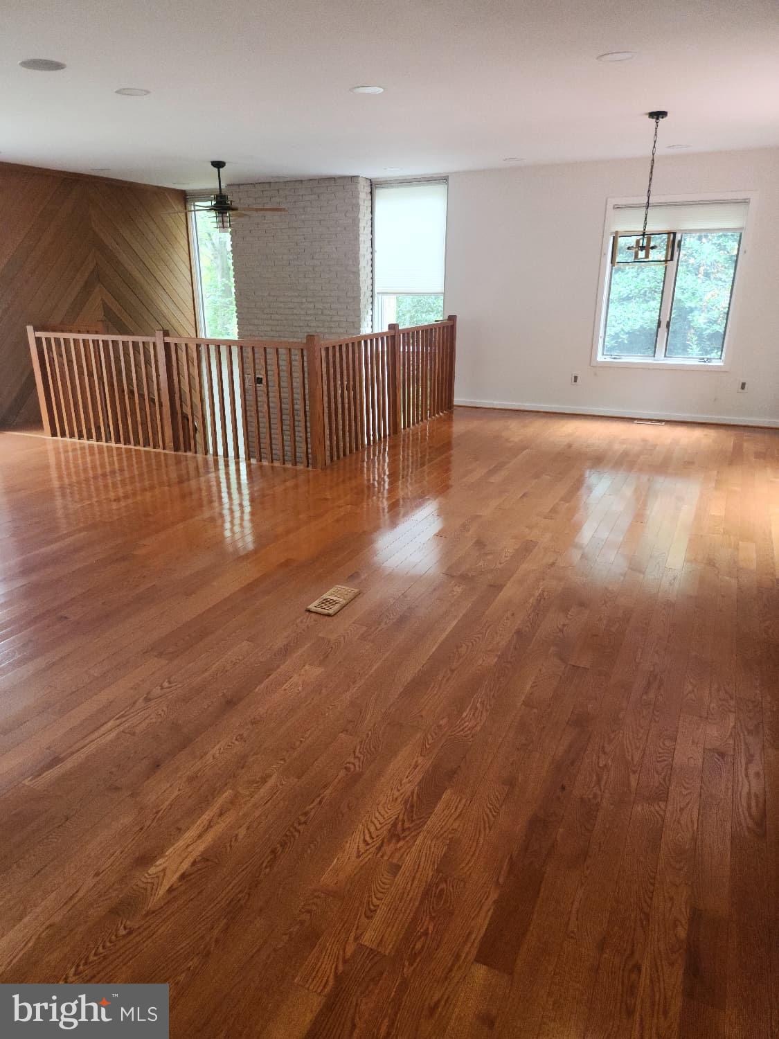 416 Marshall Manor Drive Silver Spring, MD 20905 - Photo 6 of 11 an empty room with wooden floor windows and stairs