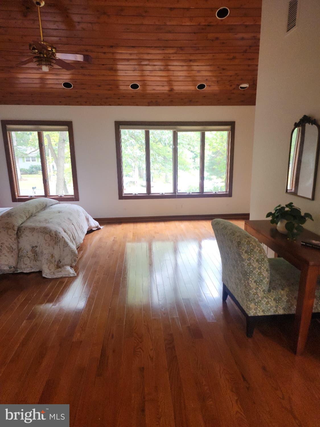 416 Marshall Manor Drive Silver Spring, MD 20905 - Photo 8 of 11 a spacious bedroom with a bed and wooden floor