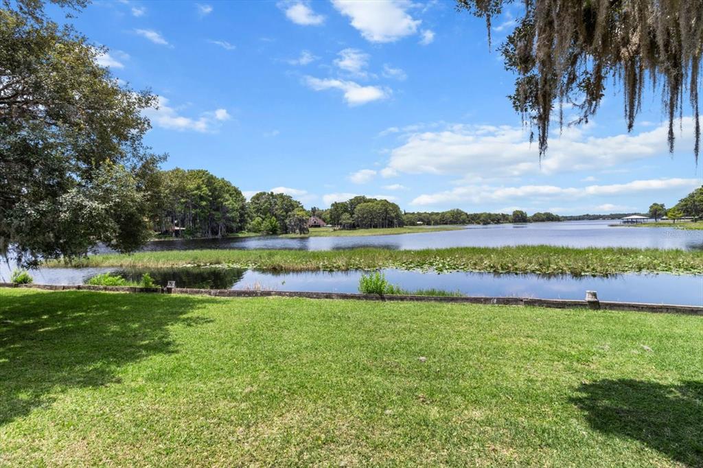 1226 South Telephone Point Road Inverness, FL 34450 - Photo 13 of 43 a view of a lake with houses in the background