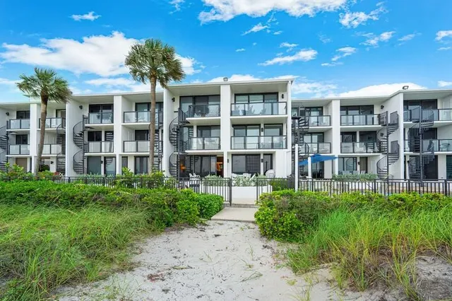 a front view of a building with a garden