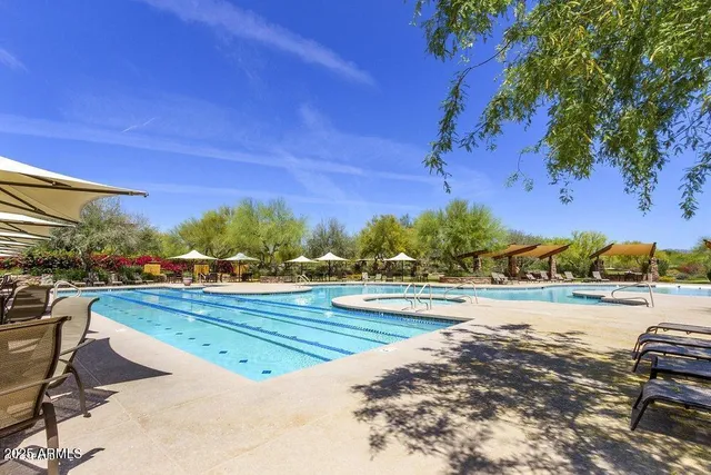a view of a swimming pool with an outdoor seating