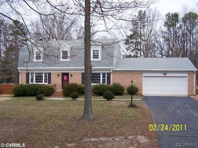 3804 Cresthill Road Chester, VA 23831 - Photo 1 of 8 a front view of a house with a yard and garage