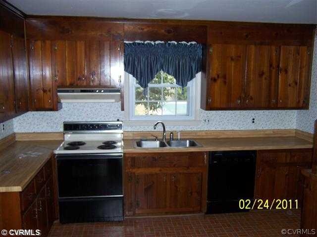 3804 Cresthill Road Chester, VA 23831 - Photo 2 of 8 a kitchen with a sink stove and cabinets