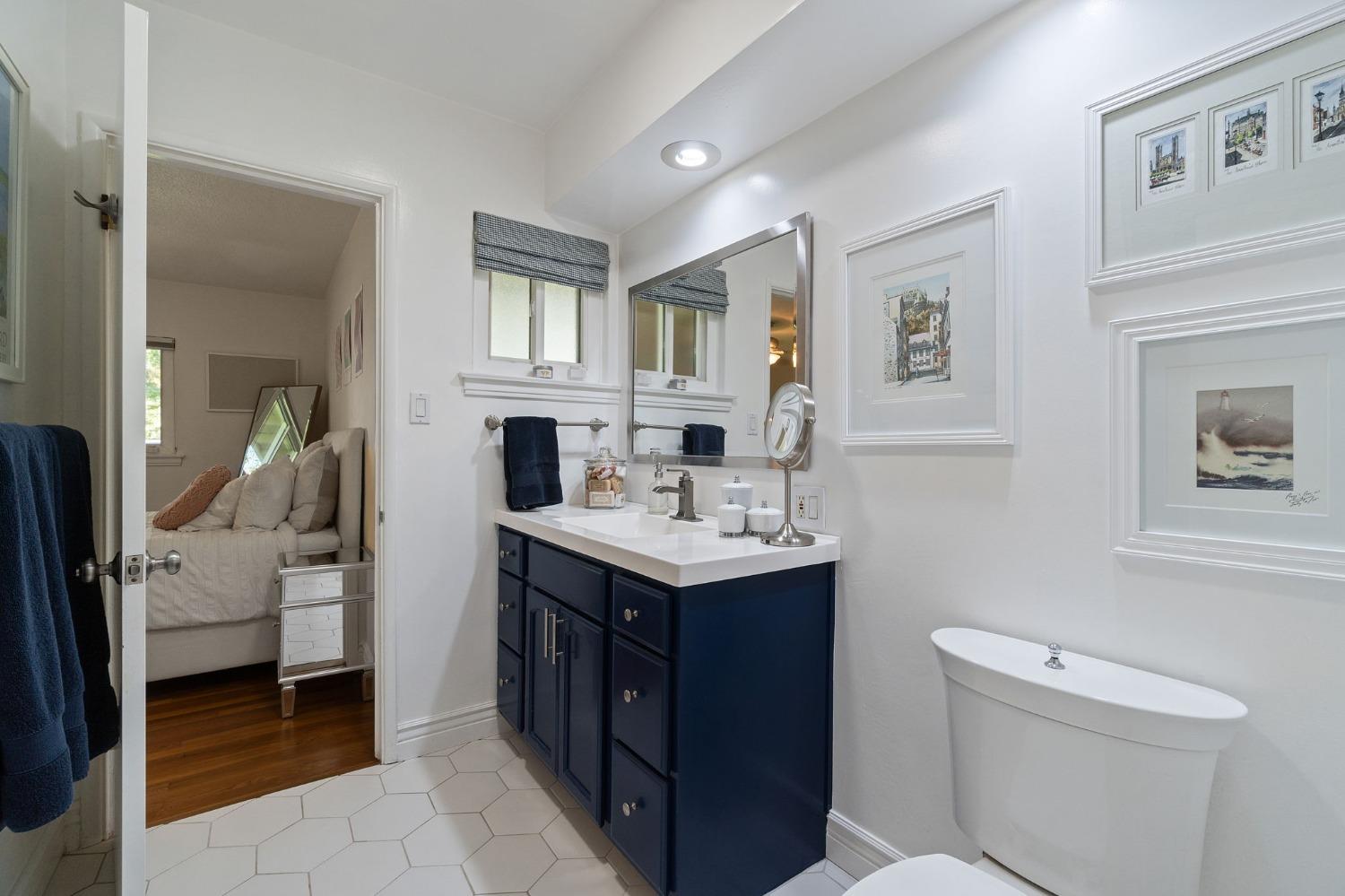 1323 West San Ramon Avenue Fresno, CA 93711 - Photo 12 of 30 a bathroom with a sink toilet and mirror