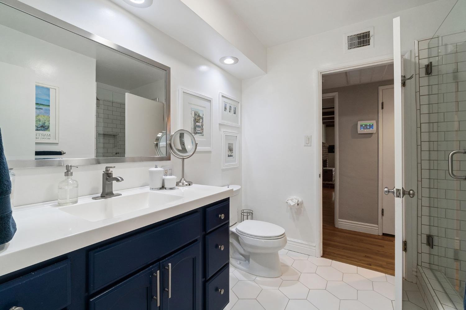 1323 West San Ramon Avenue Fresno, CA 93711 - Photo 13 of 30 a bathroom with a double vanity sink toilet and shower
