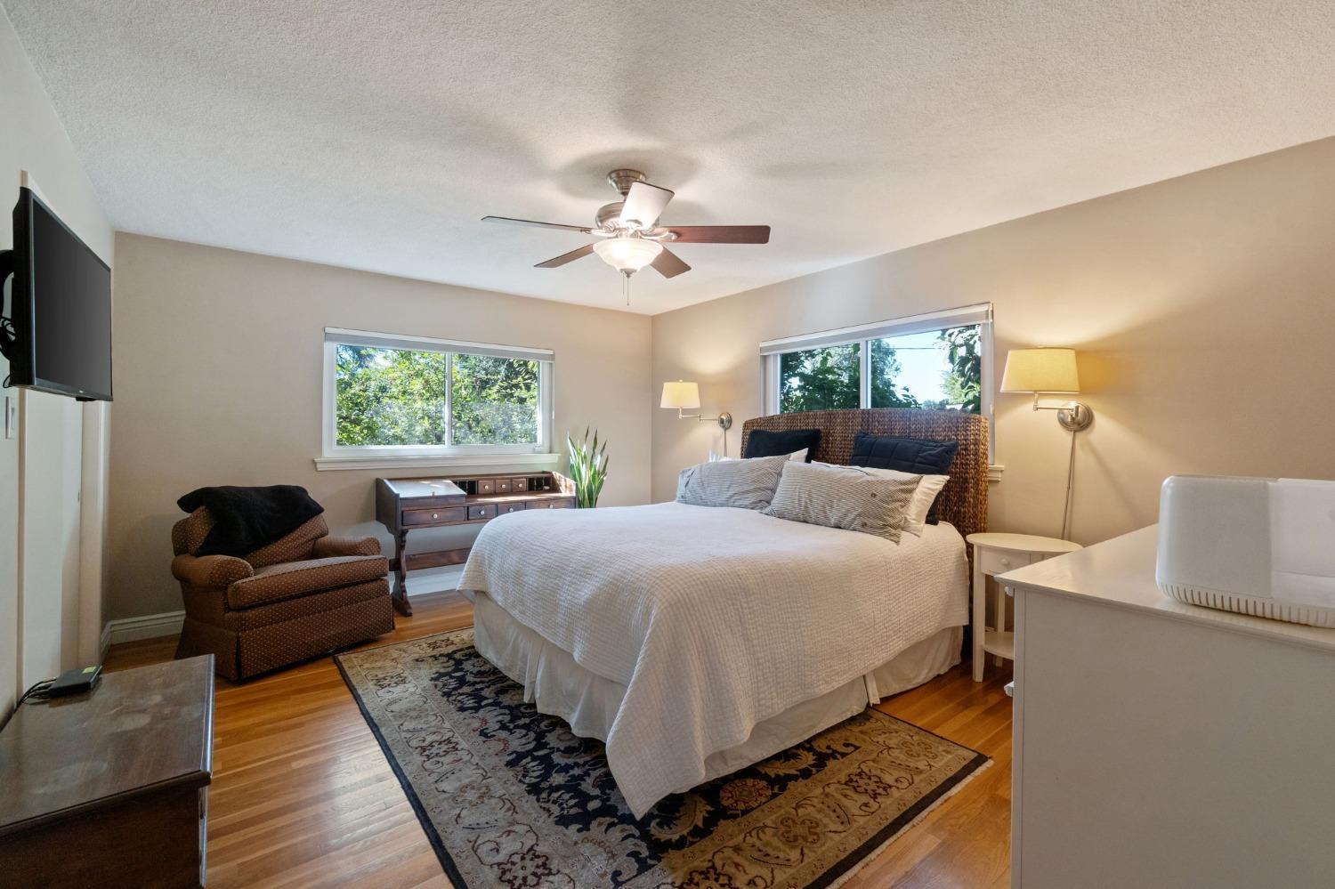 1323 West San Ramon Avenue Fresno, CA 93711 - Photo 14 of 30 a bedroom with a bed a couch and a window