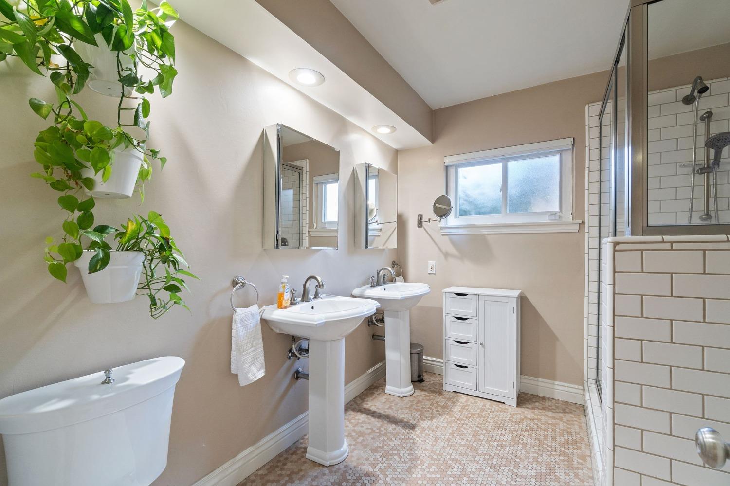 1323 West San Ramon Avenue Fresno, CA 93711 - Photo 15 of 30 a bathroom with a toilet sink and mirror