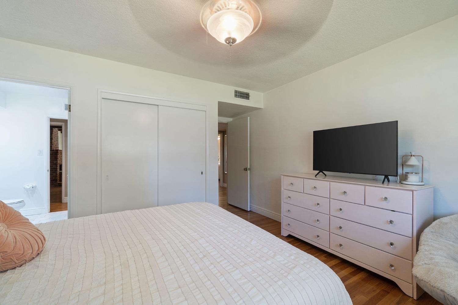 1323 West San Ramon Avenue Fresno, CA 93711 - Photo 17 of 30 a bedroom with a bed and flat screen tv
