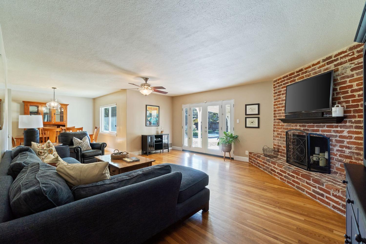 1323 West San Ramon Avenue Fresno, CA 93711 - Photo 19 of 30 a living room with furniture a fireplace and a flat screen tv