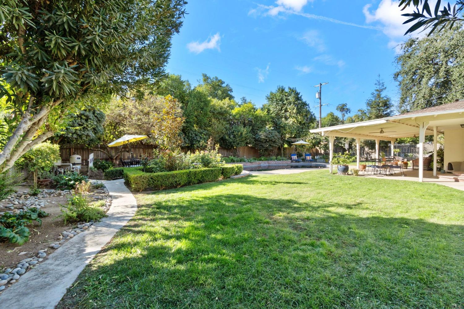 1323 West San Ramon Avenue Fresno, CA 93711 - Photo 20 of 30 a view of house with outdoor space and garden
