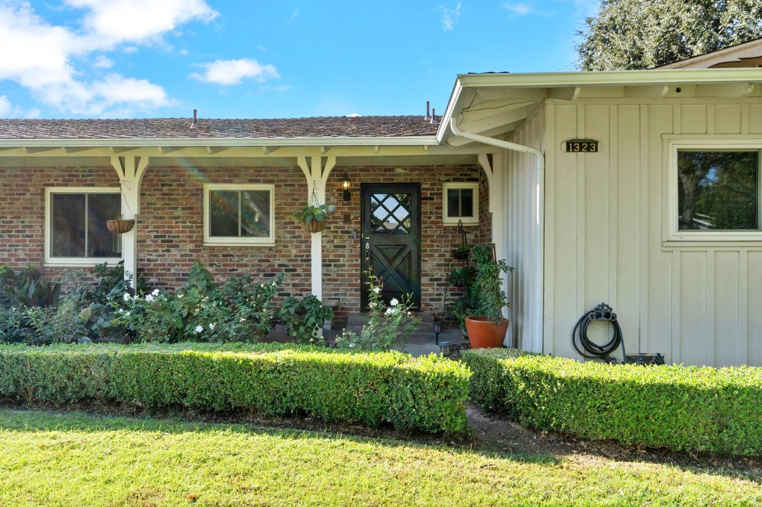 1323 West San Ramon Avenue Fresno, CA 93711 - Photo 2 of 30 a front view of a house with garden