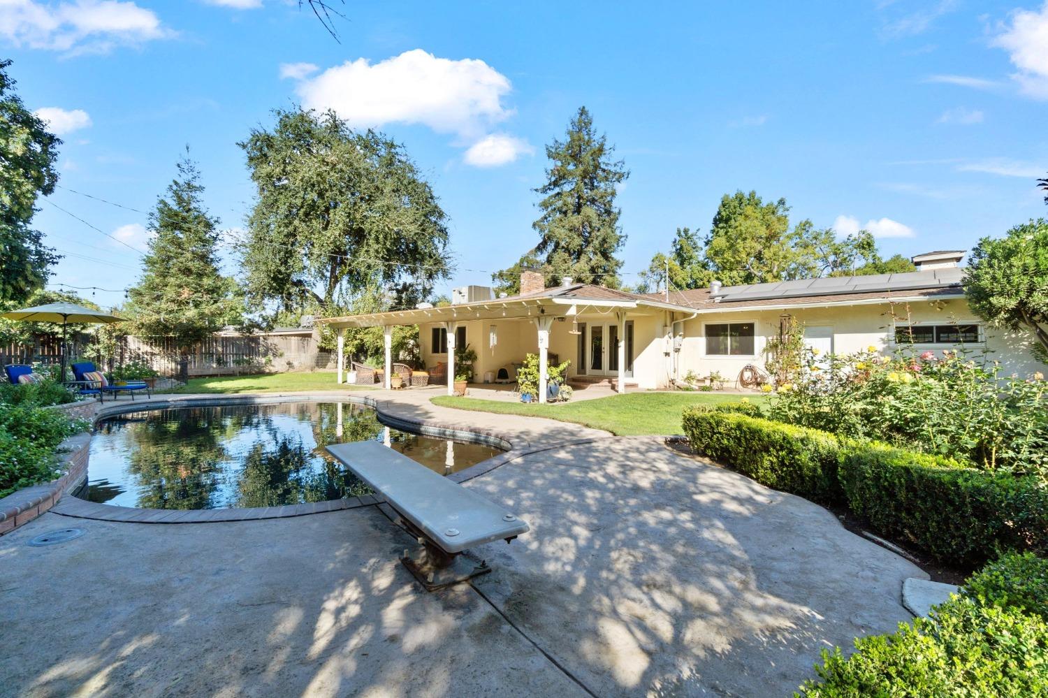 1323 West San Ramon Avenue Fresno, CA 93711 - Photo 21 of 30 a front view of a house with garden