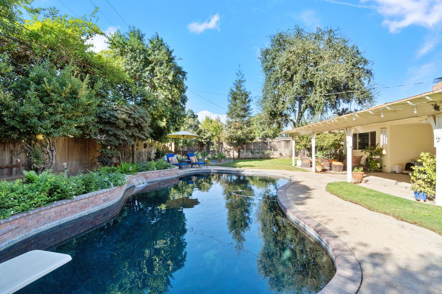 1323 West San Ramon Avenue Fresno, CA 93711 - Photo 23 of 30 a view of a swimming pool with a patio