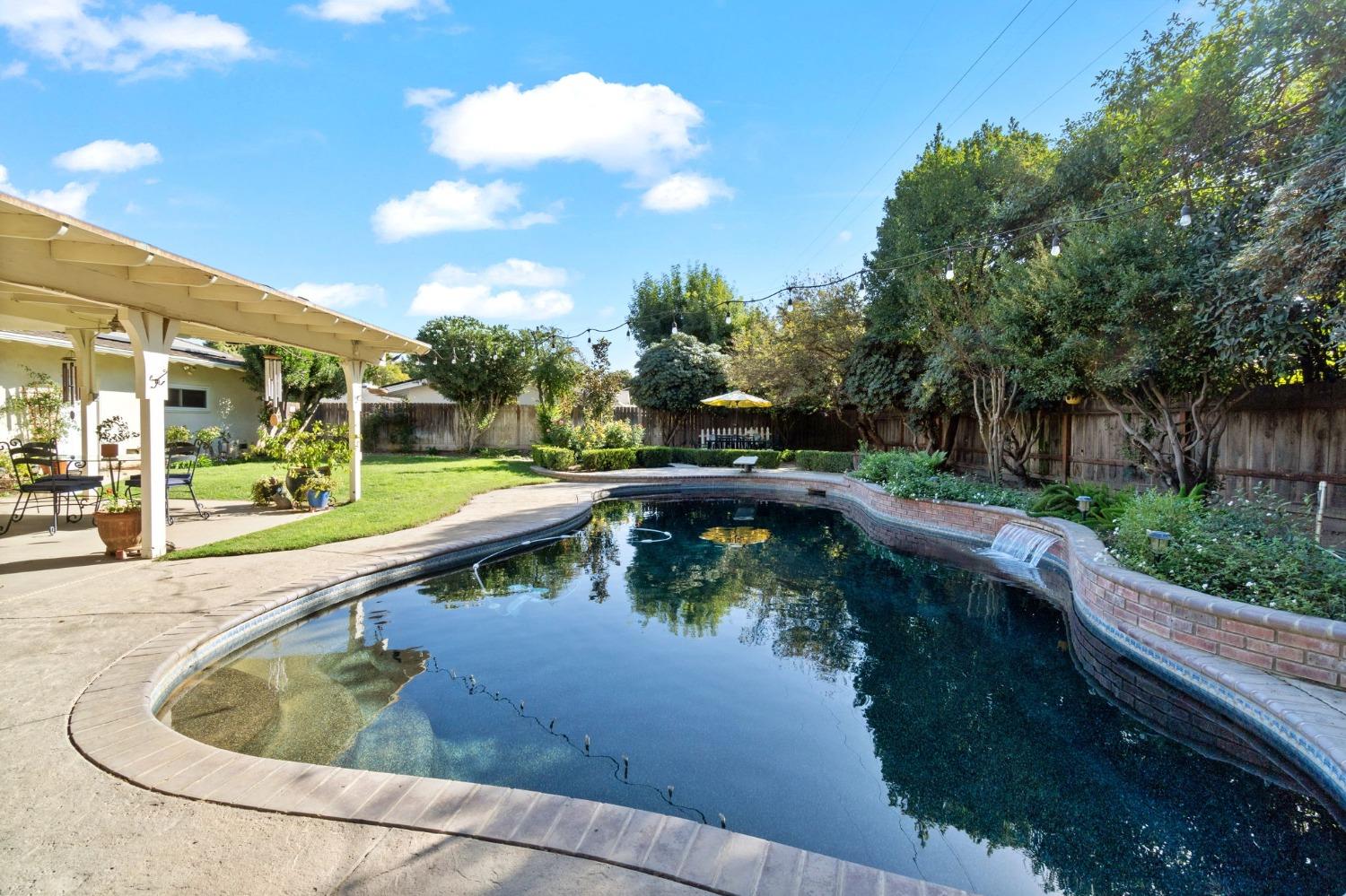 1323 West San Ramon Avenue Fresno, CA 93711 - Photo 24 of 30 a view of swimming pool with a back yard