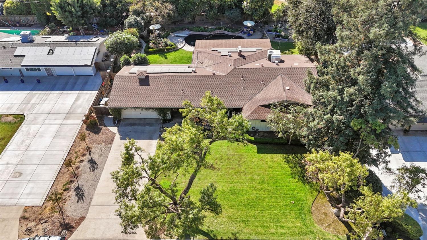 1323 West San Ramon Avenue Fresno, CA 93711 - Photo 26 of 30 aerial view of a house with a yard and potted plants