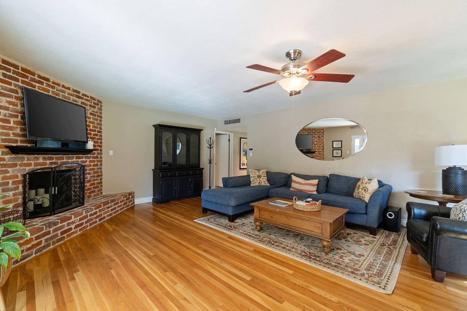 1323 West San Ramon Avenue Fresno, CA 93711 - Photo 4 of 30 a living room with furniture and a fireplace