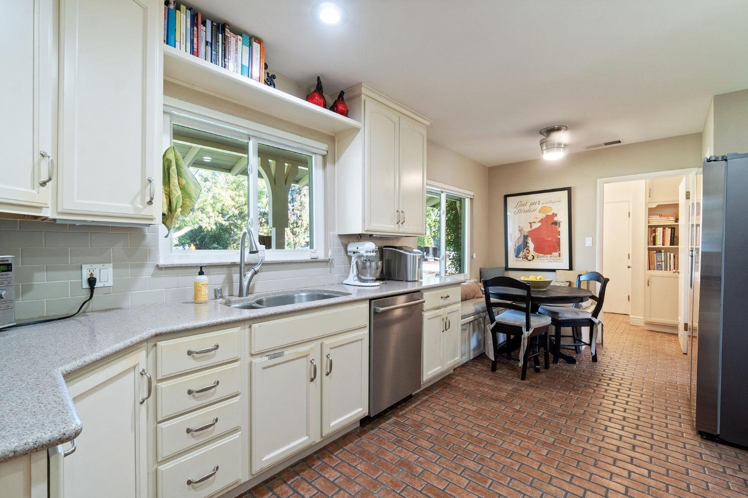1323 West San Ramon Avenue Fresno, CA 93711 - Photo 7 of 30 a kitchen with sink cabinets and dining table