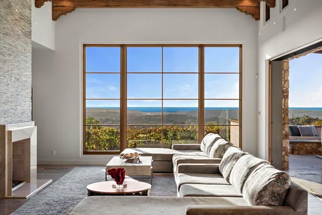 a living room with furniture and large windows