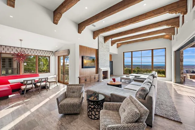 a kitchen with a stove a sink dishwasher and a dining table with wooden floor