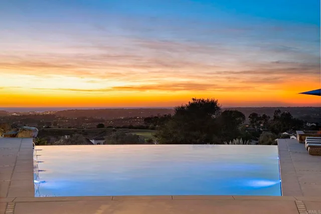 a view of mountain with sunset in background