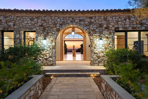 a view of living room and entryway with wooden floor
