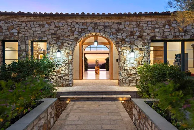 a view of living room and entryway with wooden floor