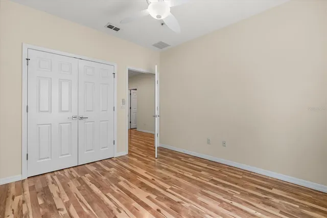 a view of a room with wooden floor and closet