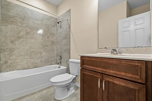 a bathroom with a sink a toilet and bathtub