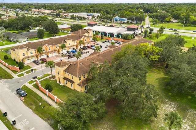 an aerial view of residential houses with outdoor space and river