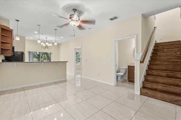 a view of a hallway with entryway and chandelier