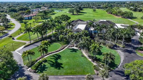an aerial view of a golf course with parking space