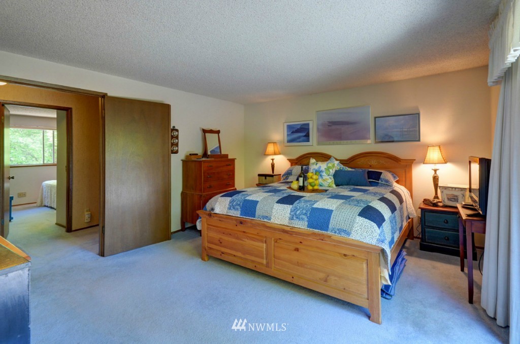 16631 24th Drive Southeast Bothell, WA 98012 - Photo 11 of 24 a bedroom with a bed and wooden floor