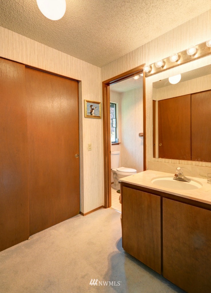 16631 24th Drive Southeast Bothell, WA 98012 - Photo 13 of 24 a bathroom with a granite countertop sink and a mirror