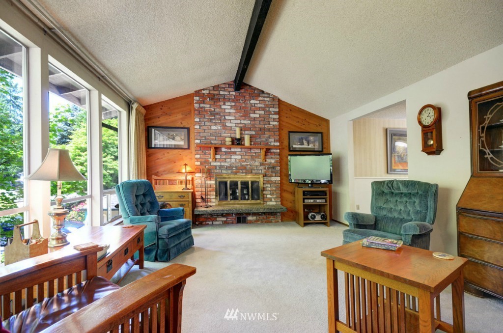 16631 24th Drive Southeast Bothell, WA 98012 - Photo 3 of 24 a living room with furniture a fireplace and large windows