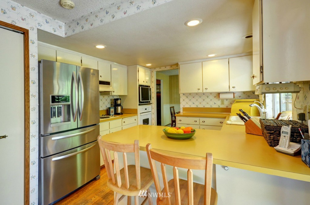16631 24th Drive Southeast Bothell, WA 98012 - Photo 6 of 24 a kitchen with a refrigerator and countertop