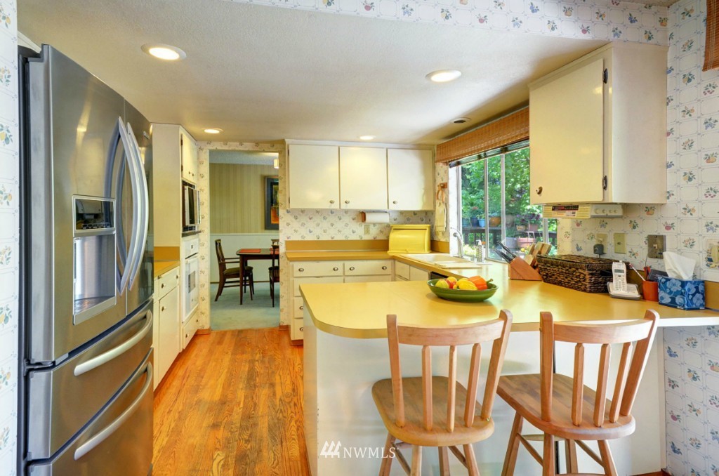 16631 24th Drive Southeast Bothell, WA 98012 - Photo 7 of 24 a dining room with stainless steel appliances furniture a large window and a kitchen view
