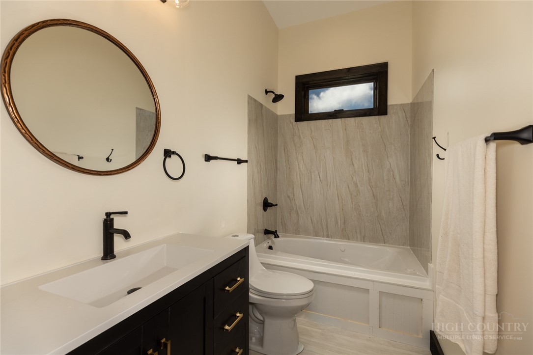 790 Howard Edmisten Road Sugar Grove, NC 28679 - Photo 20 of 45 a bathroom with a sink a toilet and a bathtub