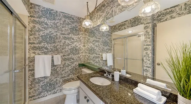 a dining room with furniture and a floor to ceiling window