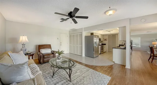 a living room with furniture a rug and a window