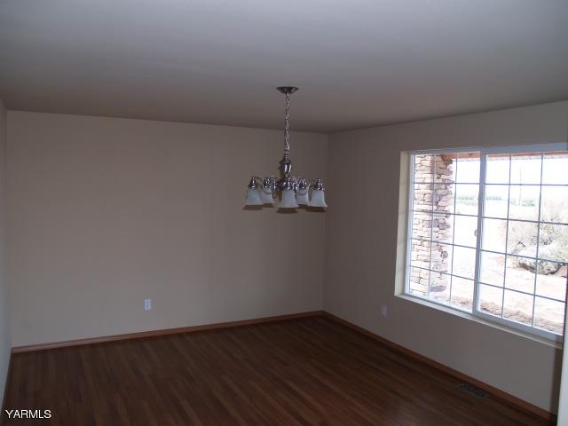 350 Keystone Road Yakima, WA 98908 - Photo 6 of 28 an empty room with wooden floor and windows