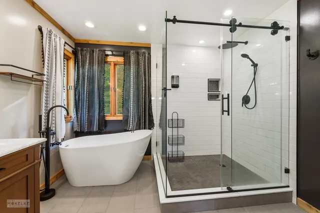 a bathroom with a bathtub and shower