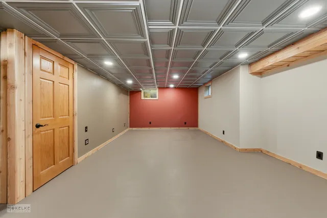 a view of empty room with wooden walls