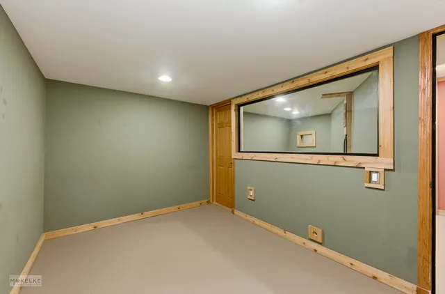 an empty room with a mirror and vanity