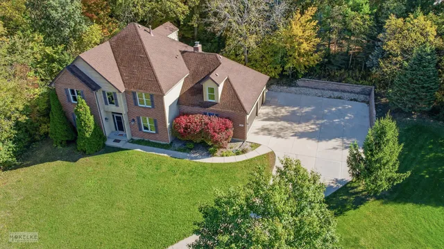 a aerial view of a house with a yard table and chairs