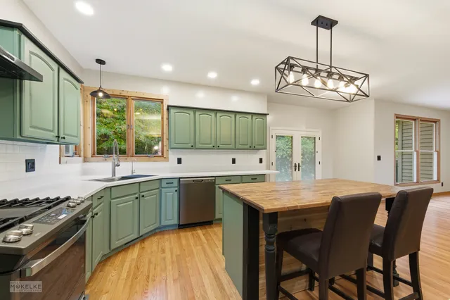 a kitchen with center island table and chairs in it