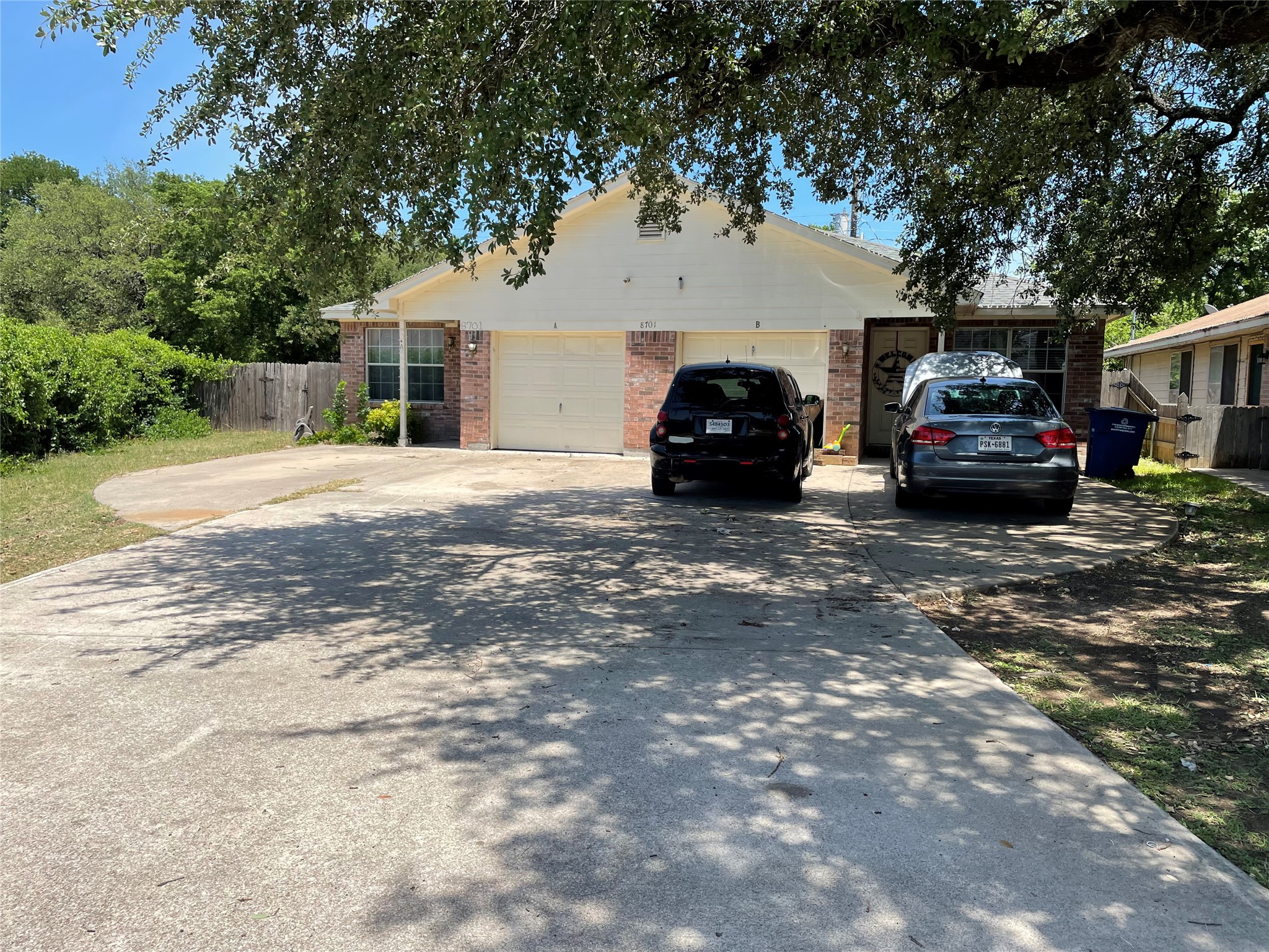 View of front of property with concrete driveway and brick siding