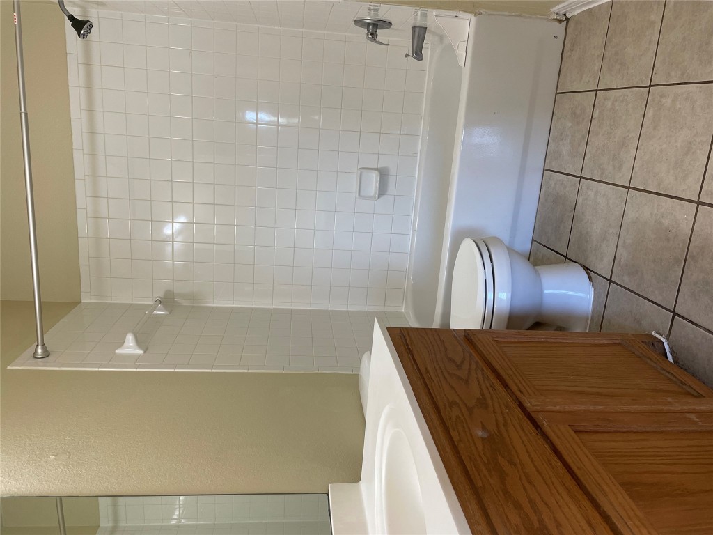 Undisclosed Address Austin, TX 78729 - Photo 7 of 8 a bathroom with a bathtub a toilet and a shower