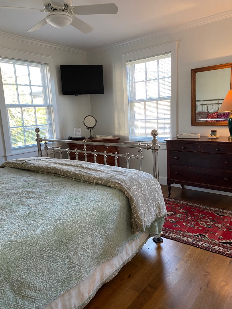 12 Spring Street Vineyard Haven, MA 02568 - Photo 17 of 40 a spacious bedroom with a bed and a flat screen tv